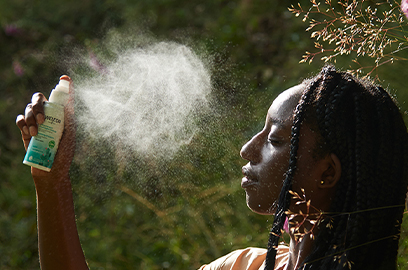 Woman spraying face with Prickly Pear Mist